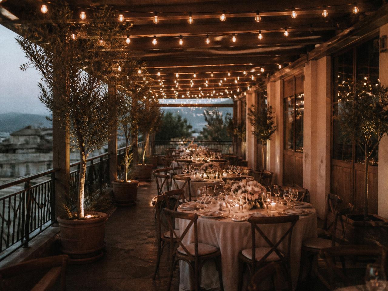 Covered restaurant terrace with string lights set for a private party